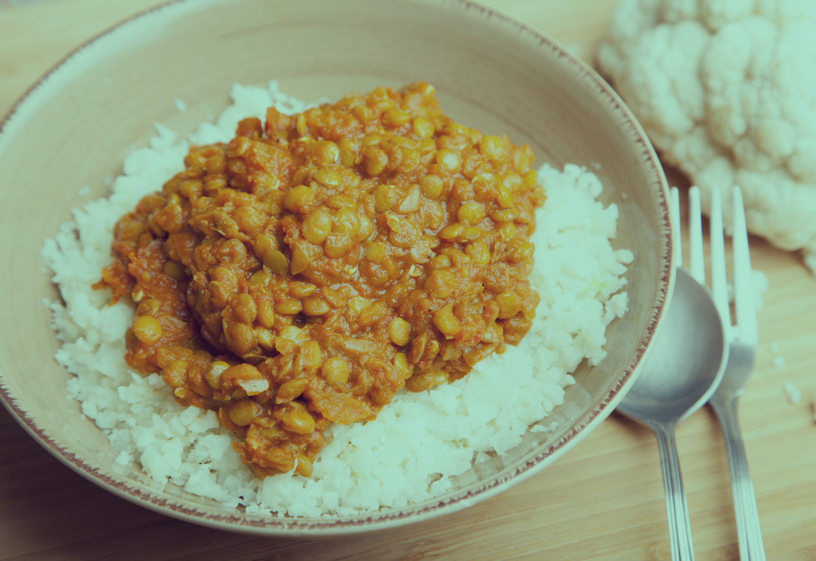 A bowl of red lentil dahl topped with fresh coriander